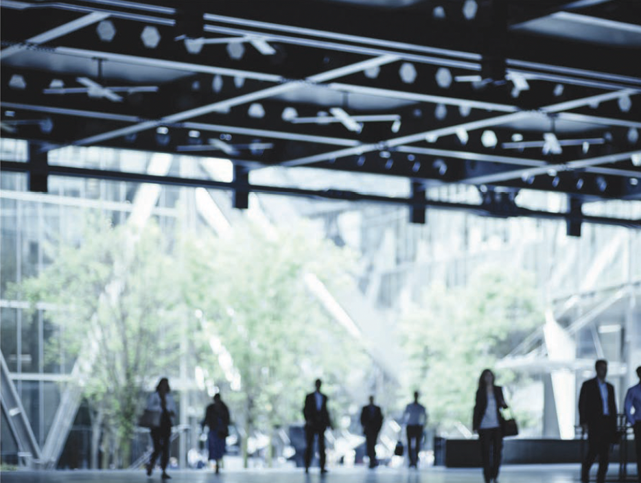 Figures moving through a glazed public foyer